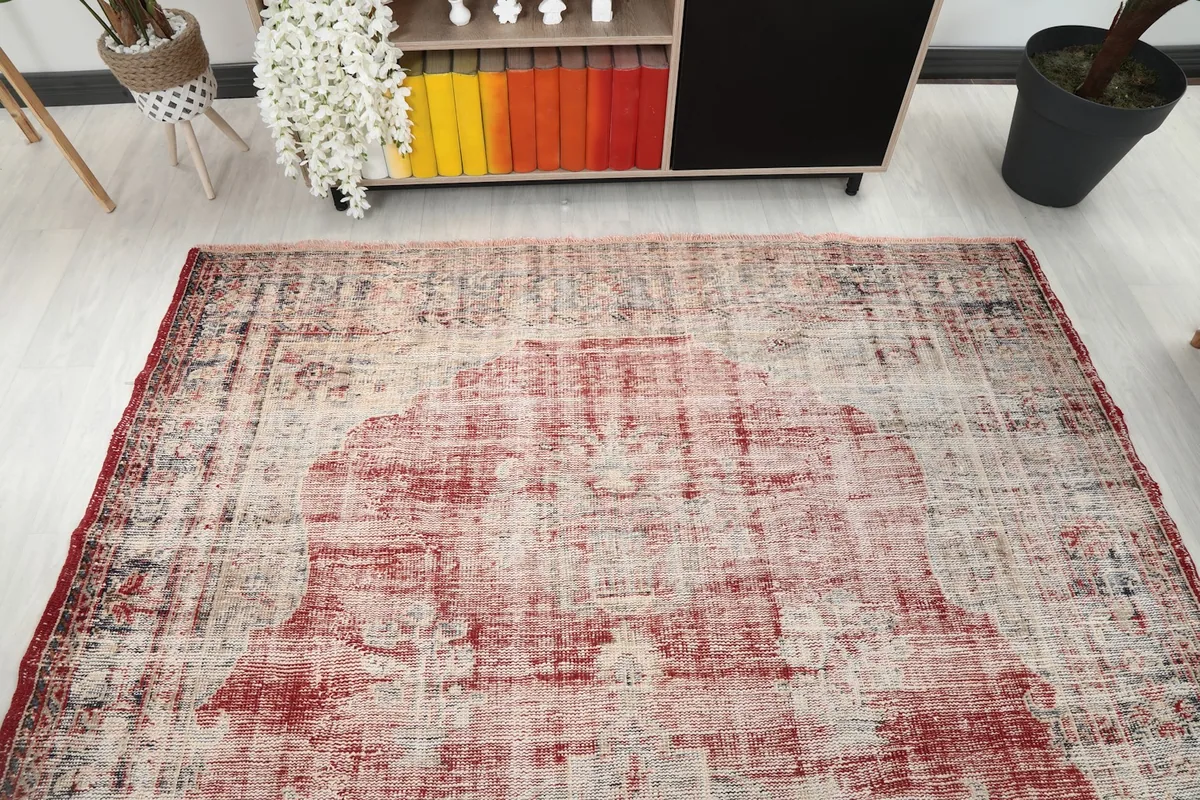 View of the vintage rug from the end, placed in a room with light flooring