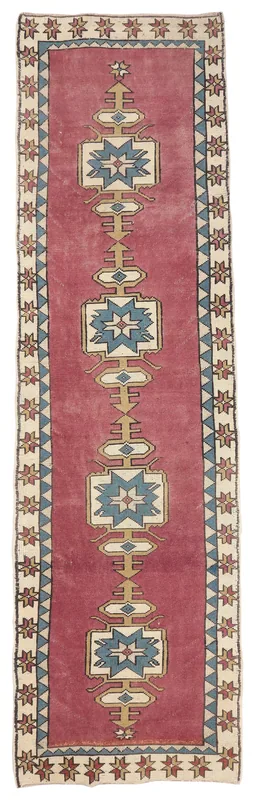 Full top view of the 3'1" x 11'0" vintage Anatolian runner rug with a rose field and geometric motifs