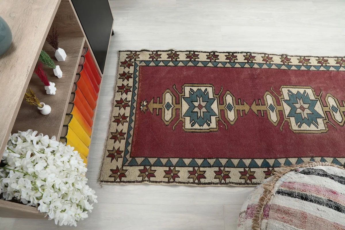 Overhead shot of the runner rug's end, highlighting the beige border and geometric details