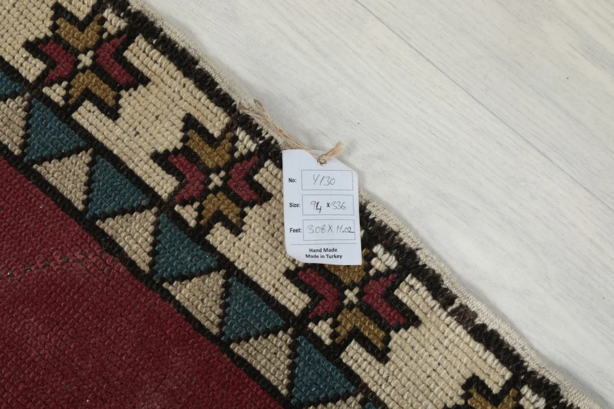 Close-up of the rug's corner with a product tag showing dimensions and origin