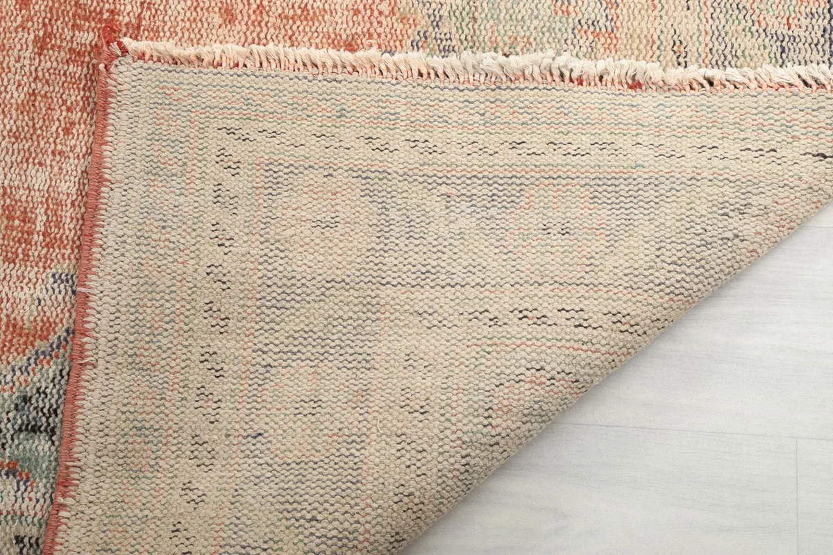 Close-up of the rug's reverse side, showing the tight knotting and construction.