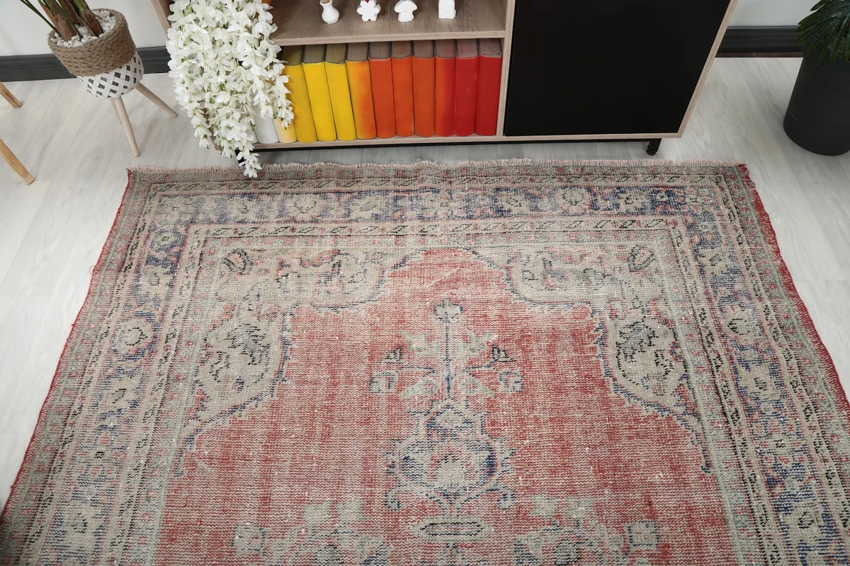Angle view of the rug's top half, showing the medallion and one end of the border