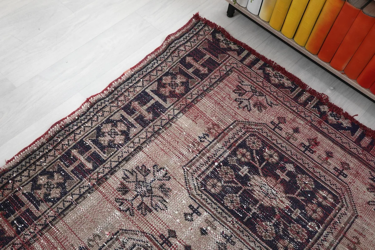 Angled detail of one end of the rug, highlighting the border and faded sections