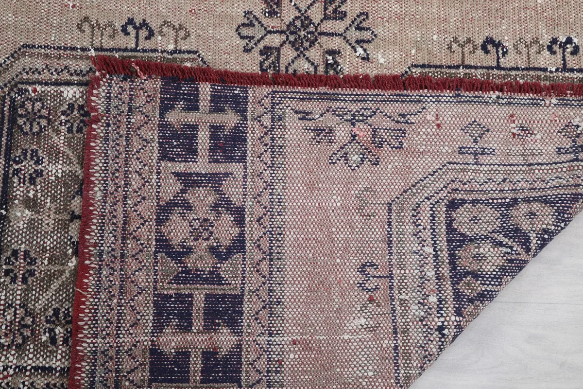 Another folded corner, revealing the reverse side and the tight knotting