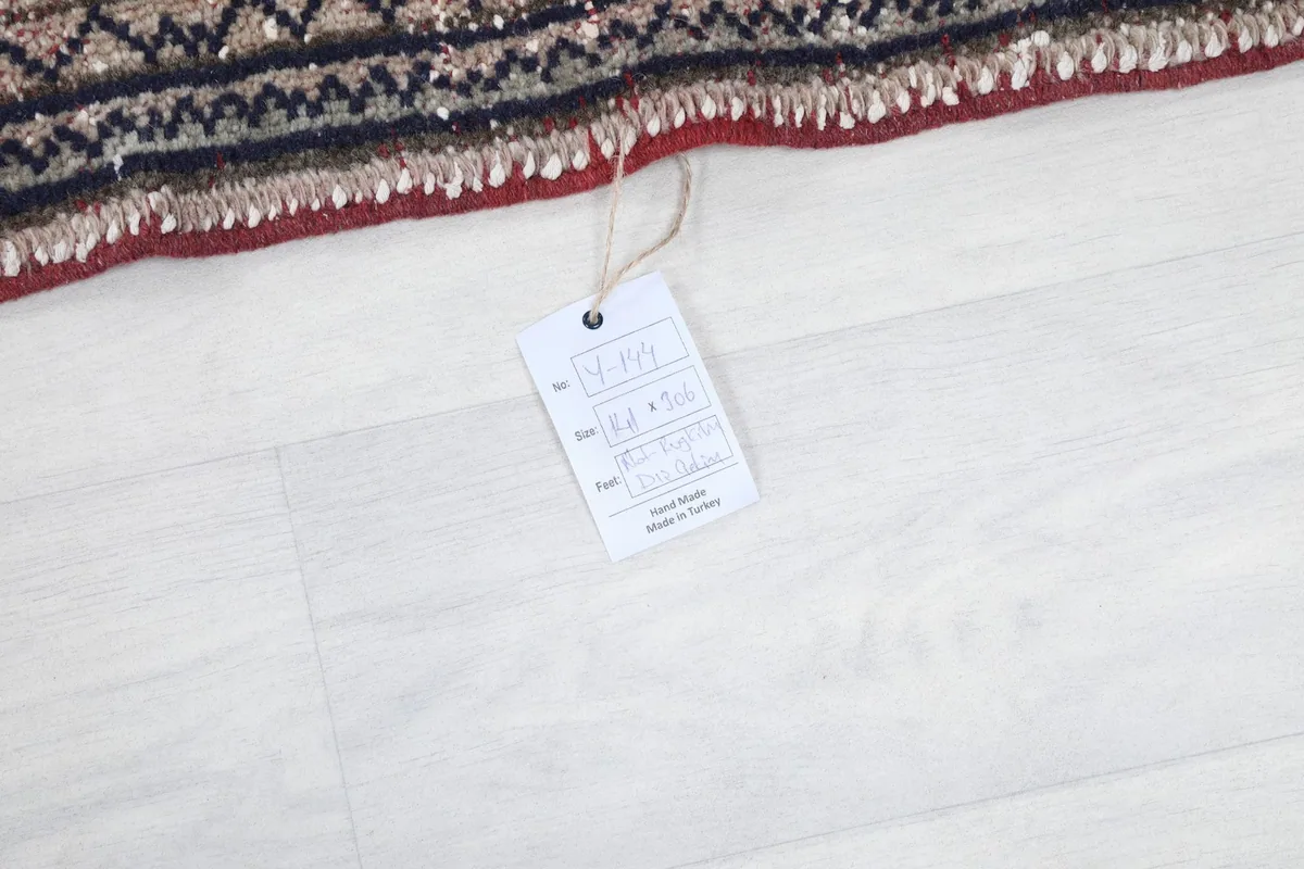 Close-up of the RugsKilim product tag attached to the rug's edge