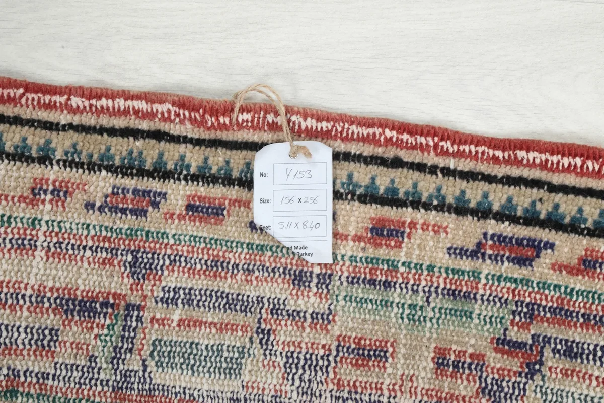 Close-up of the rug's tag, indicating its origin, materials, and unique product number.