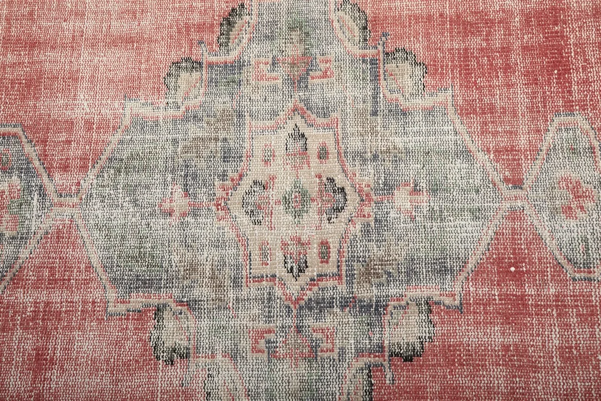 Detailed overhead view of the intricate gray and ivory medallion pattern on the rug