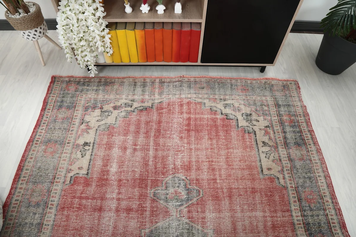 Overhead view of the vintage rose rug in the room setting, highlighting its overall pattern