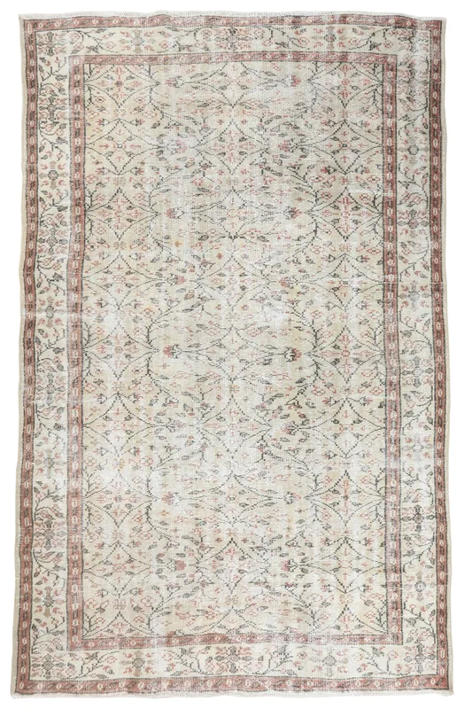 Full overhead view of the 6x9 cream vintage Anatolian rug with floral and geometric motifs