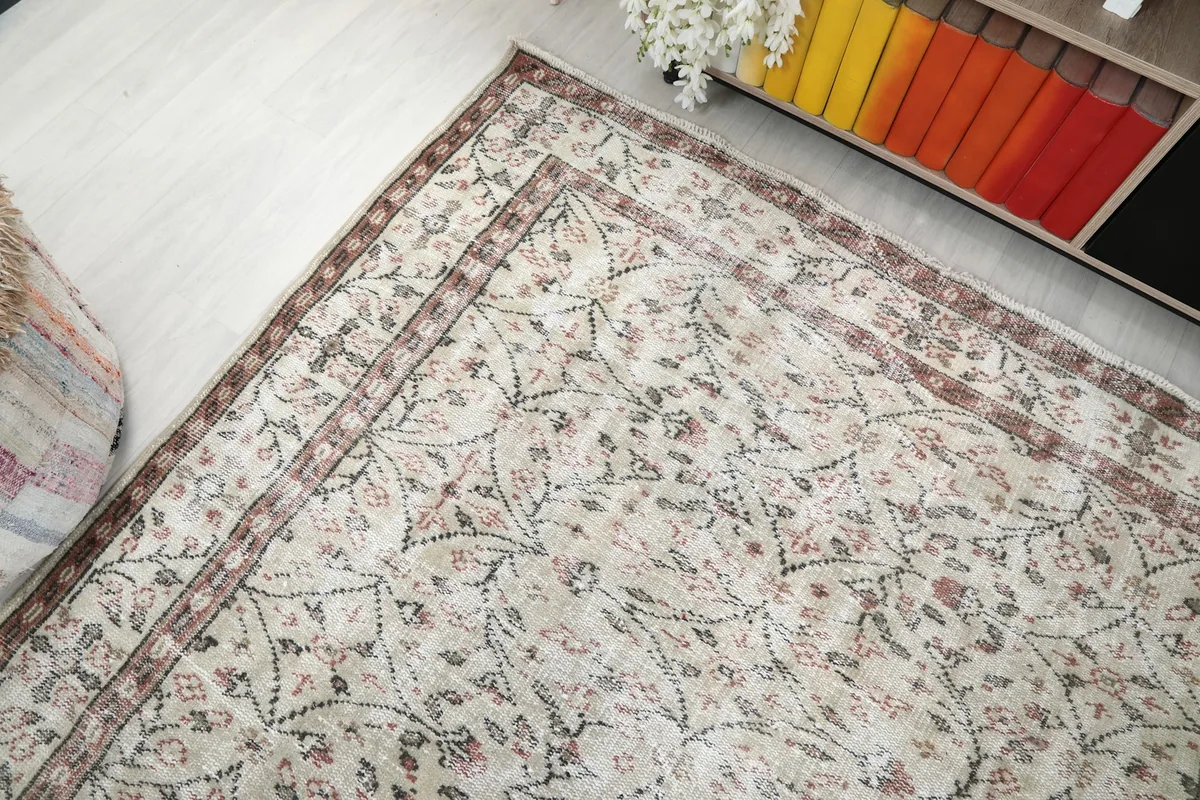 View from above, showcasing the rug's full pattern and border in the room setting