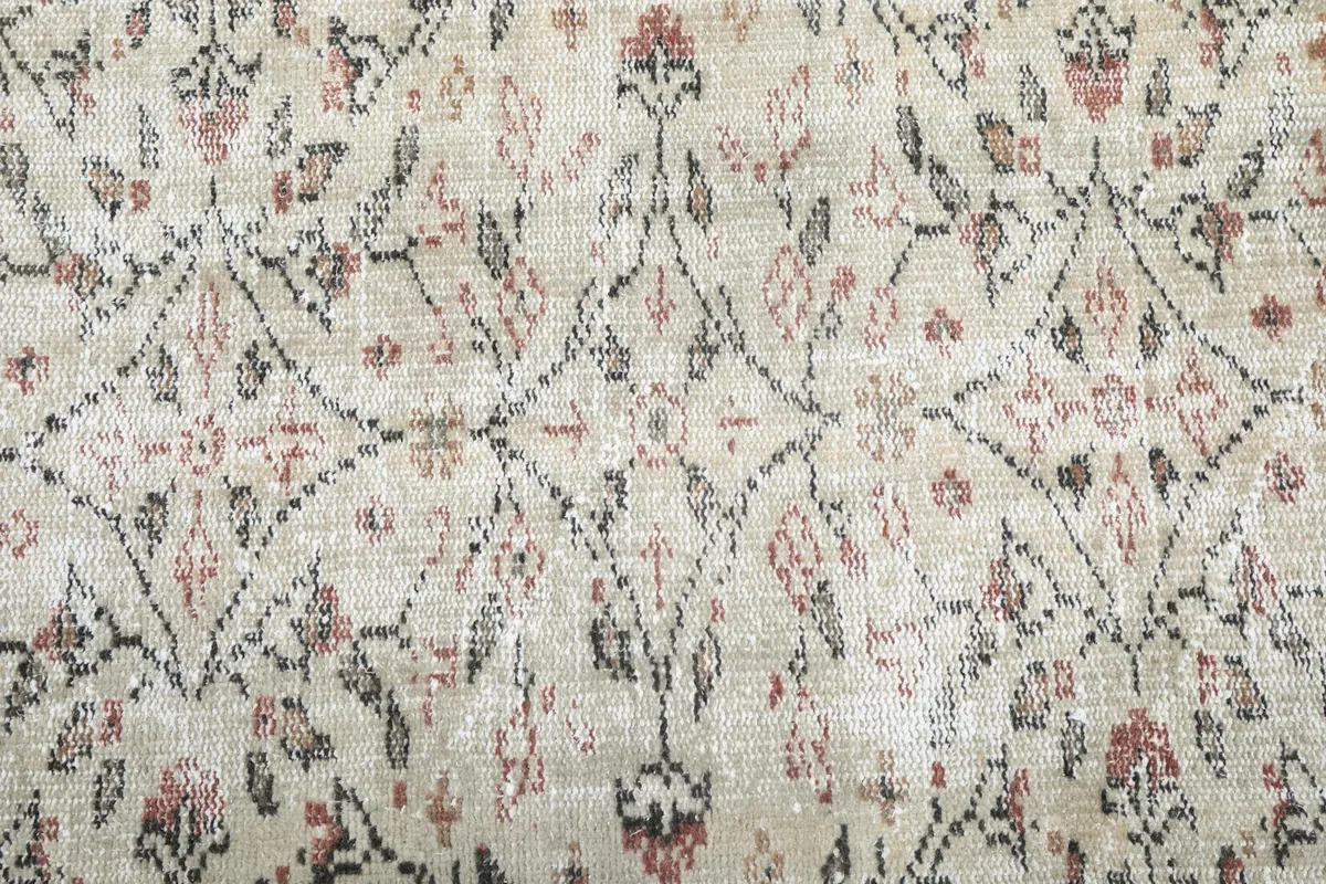 Close-up of the rug's central design, showing individual hand-knotted wool fibers and pattern clarity