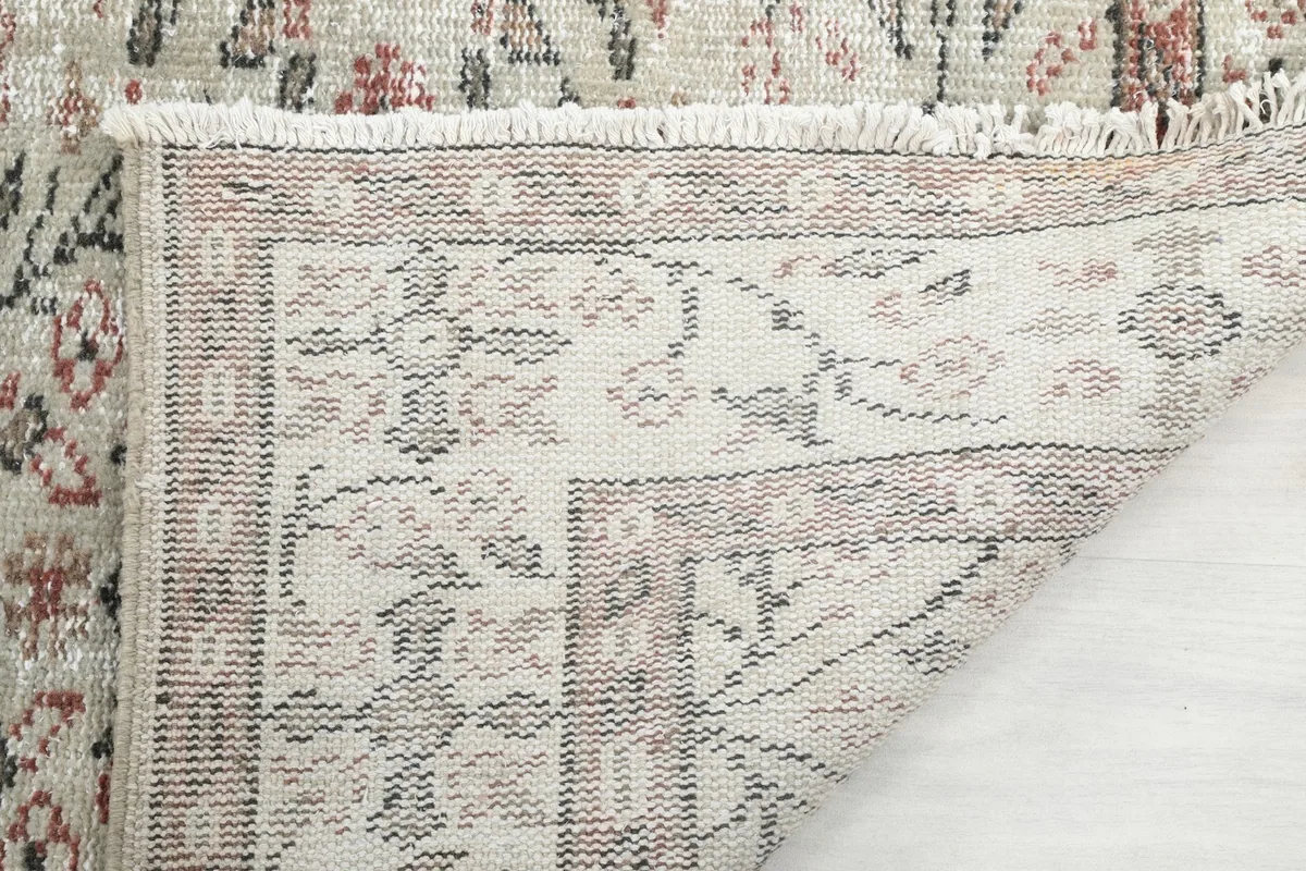 Close-up of the rug's underside, showing the reverse of the hand-knotted wool pile and cotton foundation