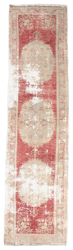 Full overhead view of the red and beige distressed vintage runner rug