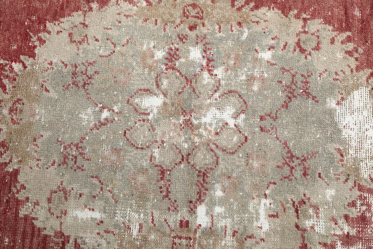 Macro view of a floral medallion pattern, revealing the intricate hand-knotted wool texture