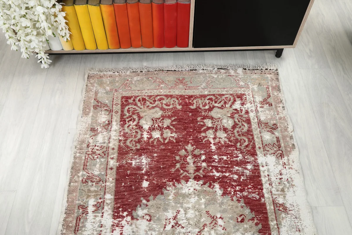 Overhead view of one end of the runner rug, displaying its floral motifs and color variations