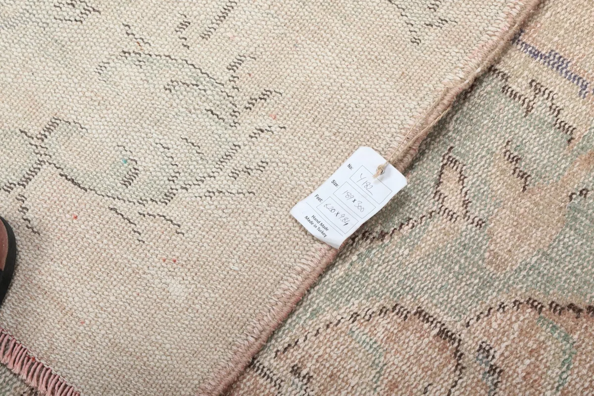 Close-up of the rug's reverse side with a product tag, showing the weave and construction
