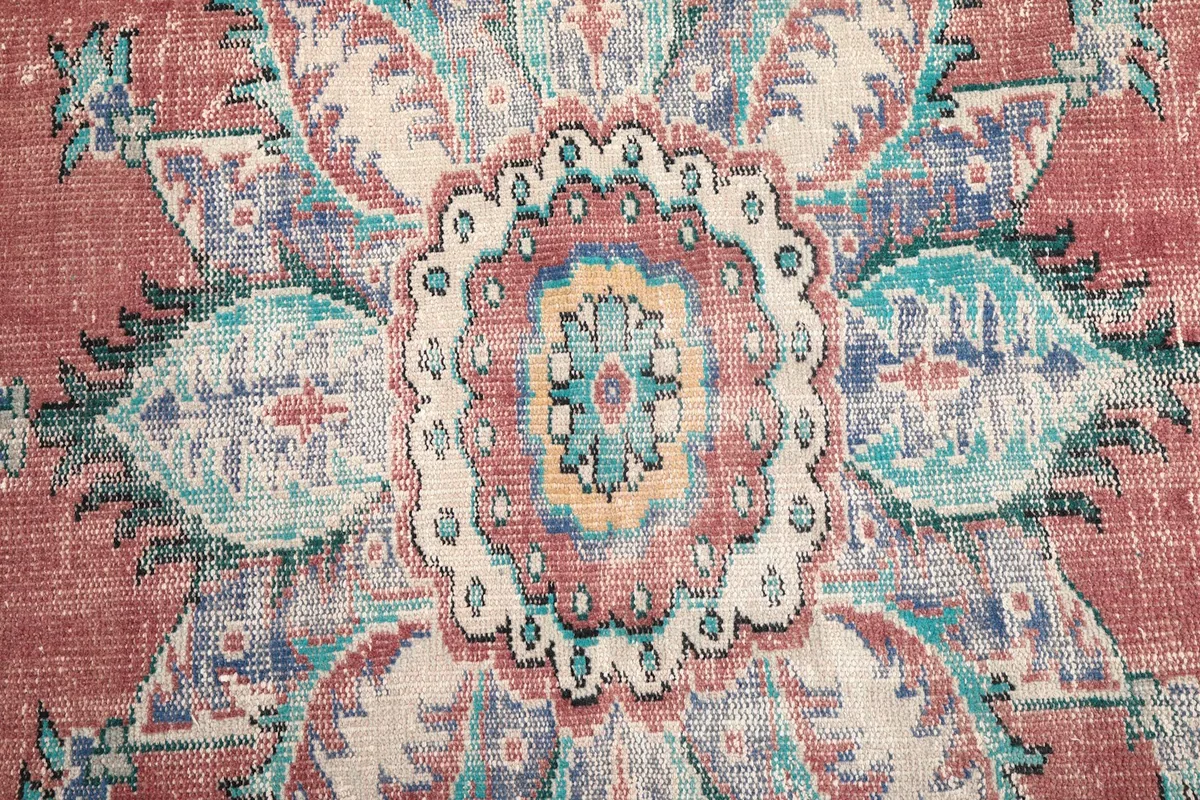 Close-up of the intricate patterns and colors within the rug's central medallion