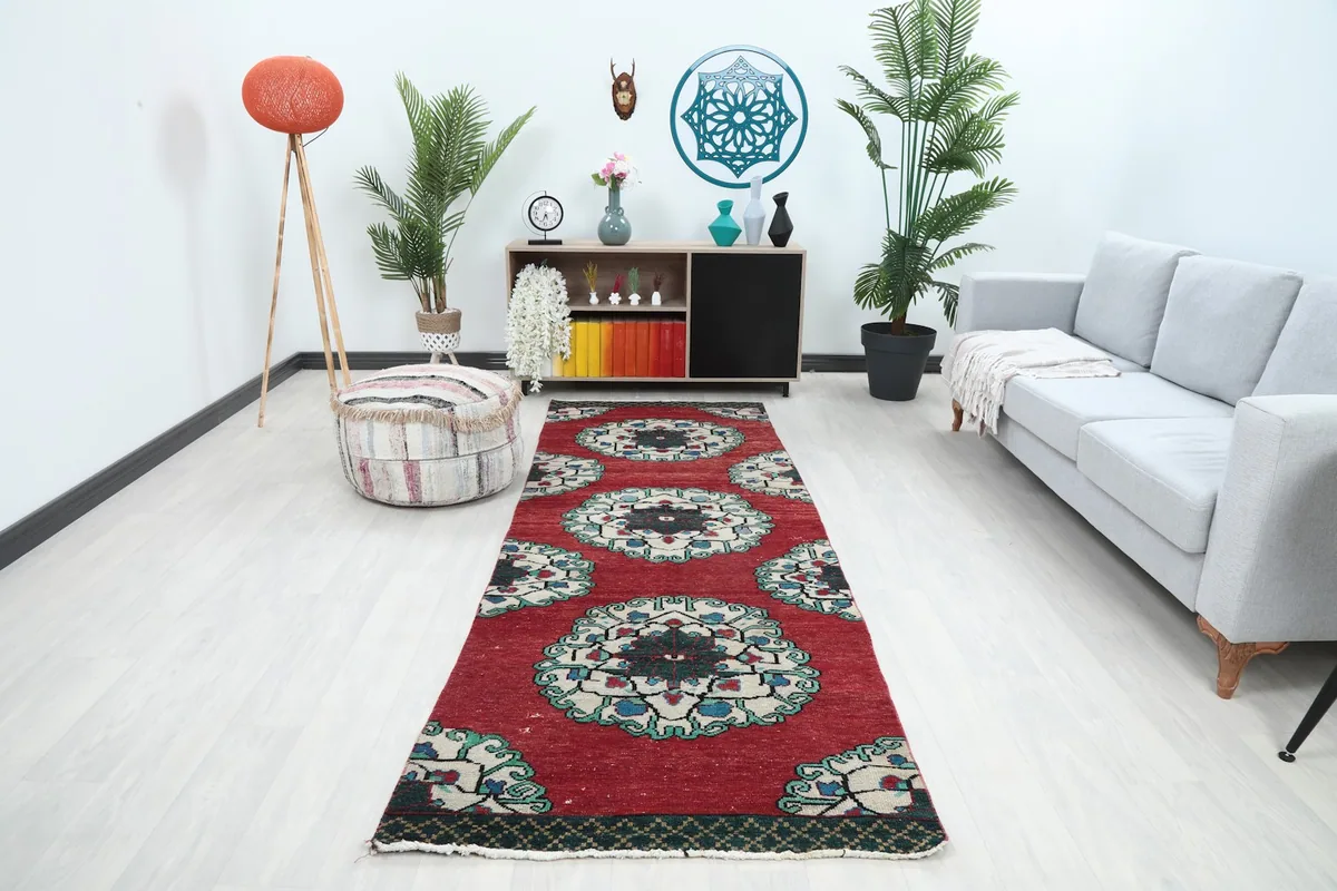Runner rug displayed in a bright modern room with a gray sofa and plants.