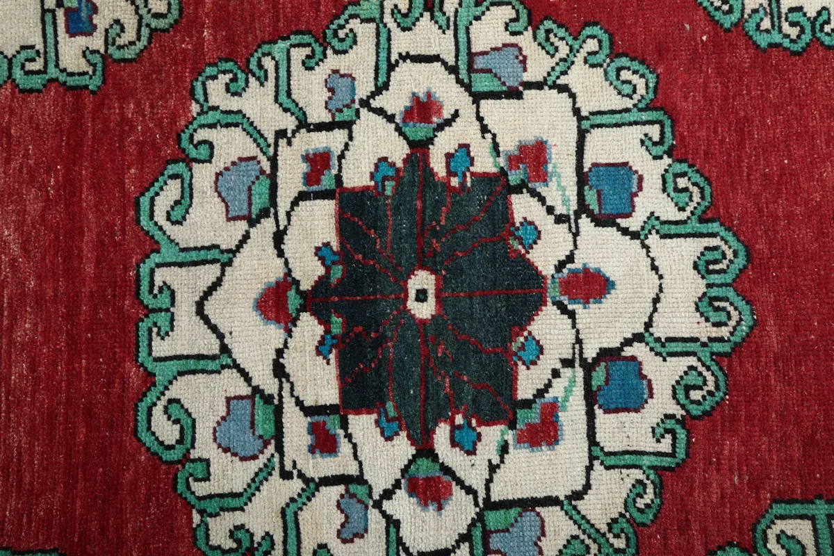 Close-up of a central geometric medallion with ivory, blue, and black details.