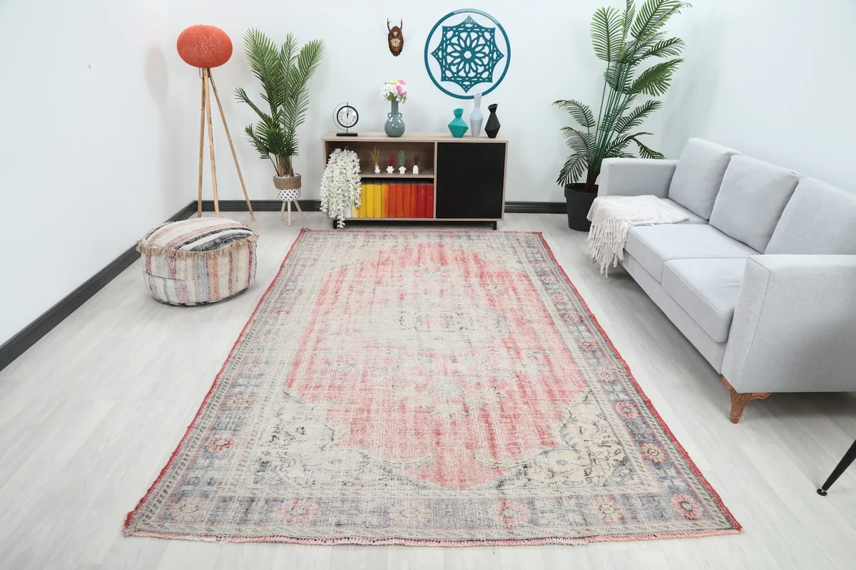 Vintage Anatolian rug with rose and ivory colors in a modern living room setting