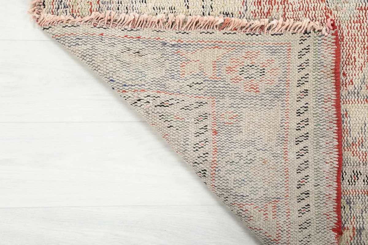 Close-up of the rug's reverse side, showing the hand-knotted construction and foundation.