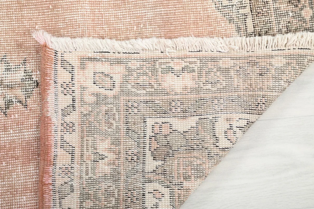 Underside of the hand-knotted rug, showing the cotton foundation and reverse of the pattern