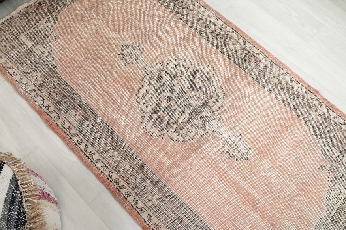 Overhead view of the rug's central medallion and faded rose field