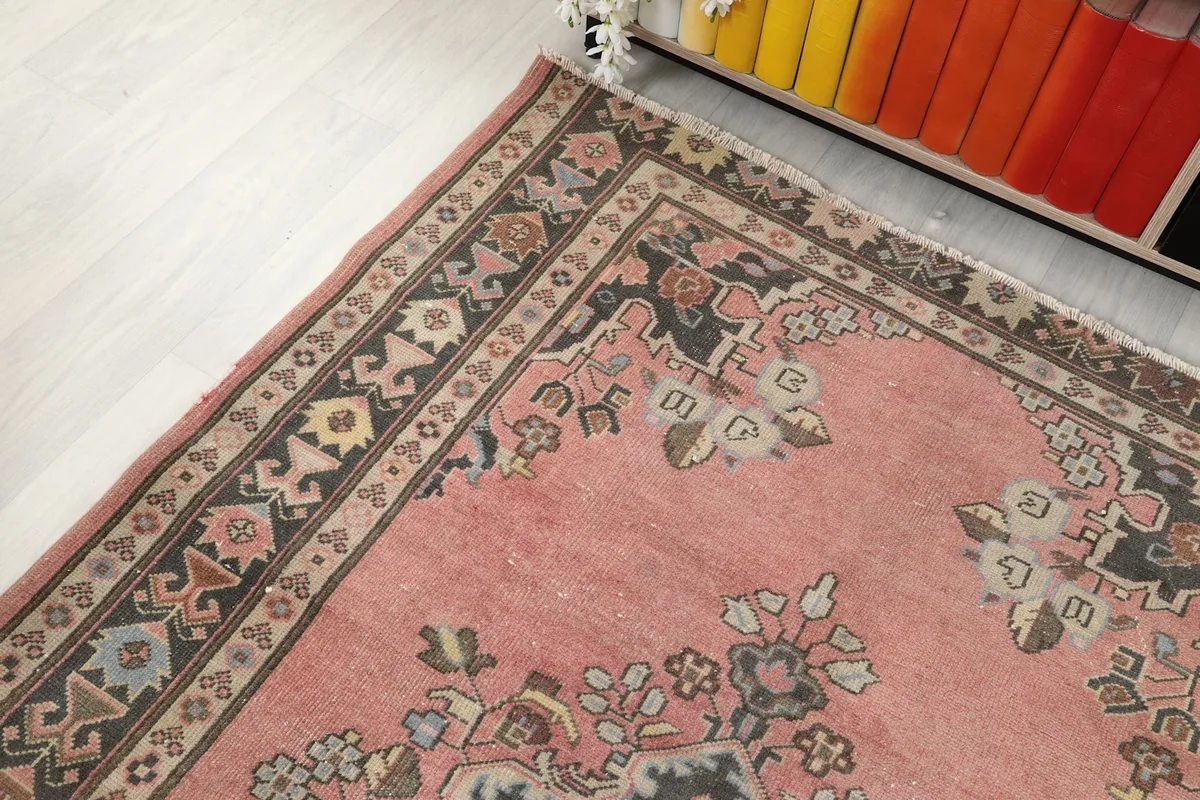 Corner view of the rug, showcasing the border design and main field color