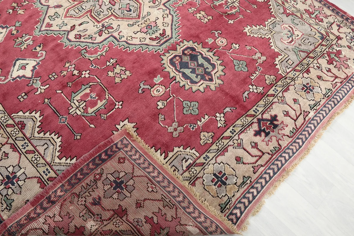 Folded corner of the rug revealing the pile and underside, showing the hand-knotted structure