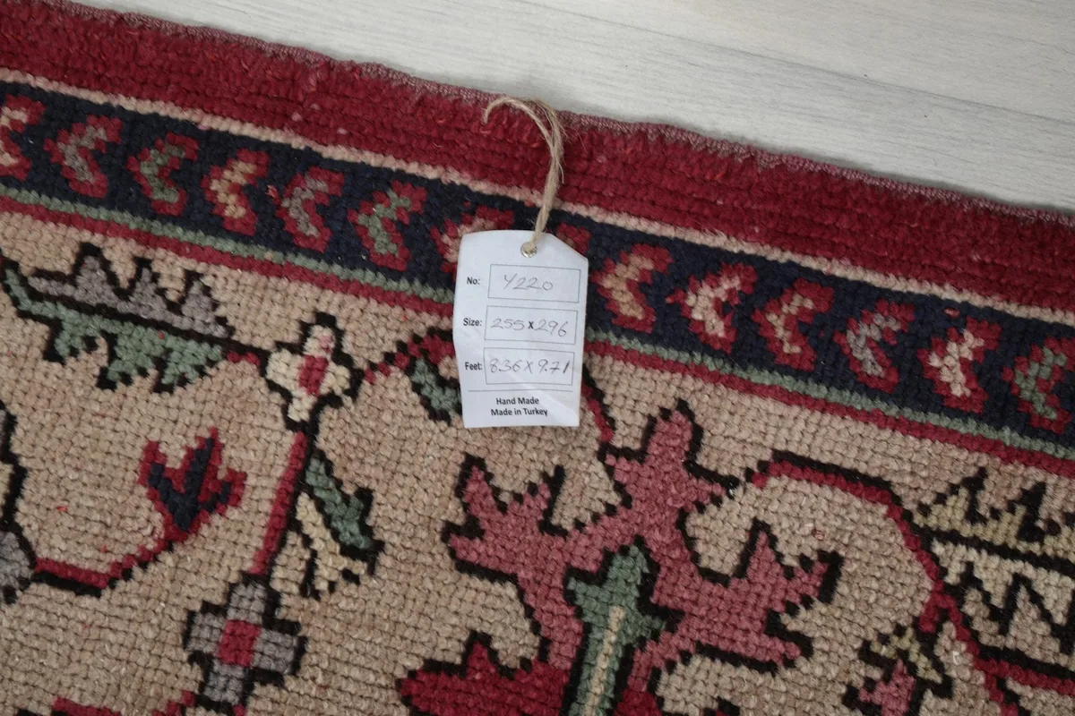 Product tag attached to the rug, showing details like 'hand made in Turkey'