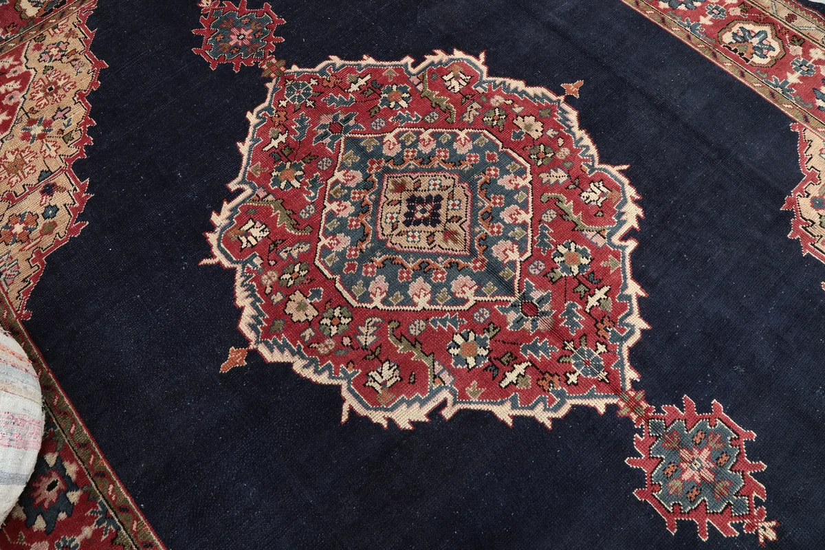 Close-up of the central medallion on the Navy Medallion Anatolian Rug, showing intricate floral and geometric patterns.