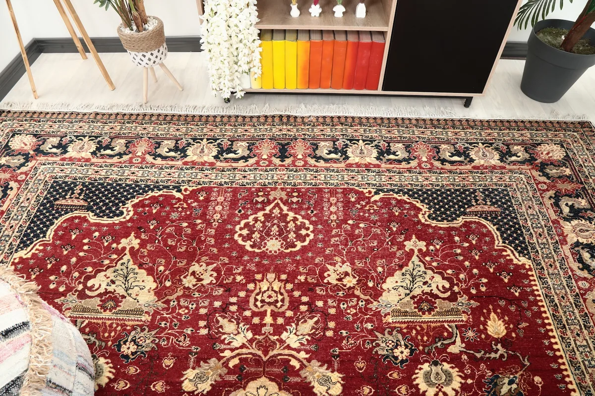 Overhead angle of the rug showing a section of the red field and border