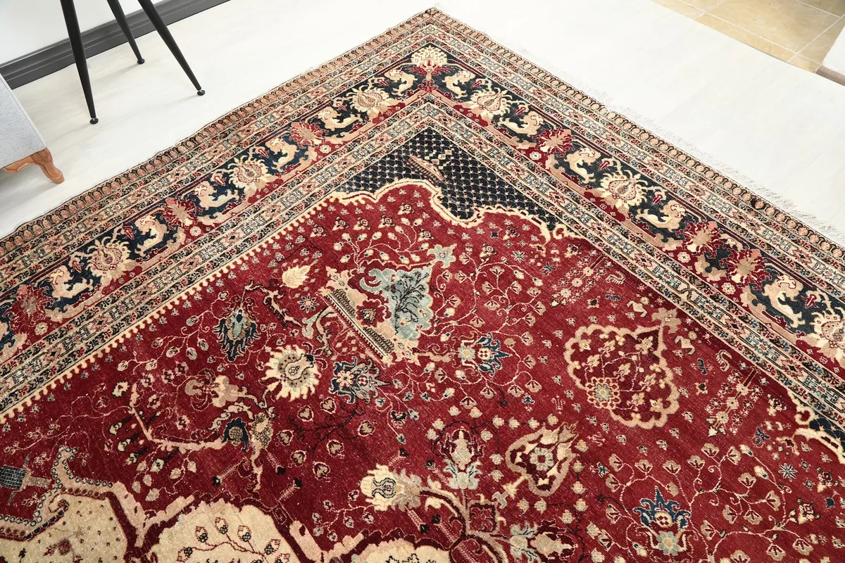 Detailed corner of the rug, focusing on the intricate floral motifs and colors