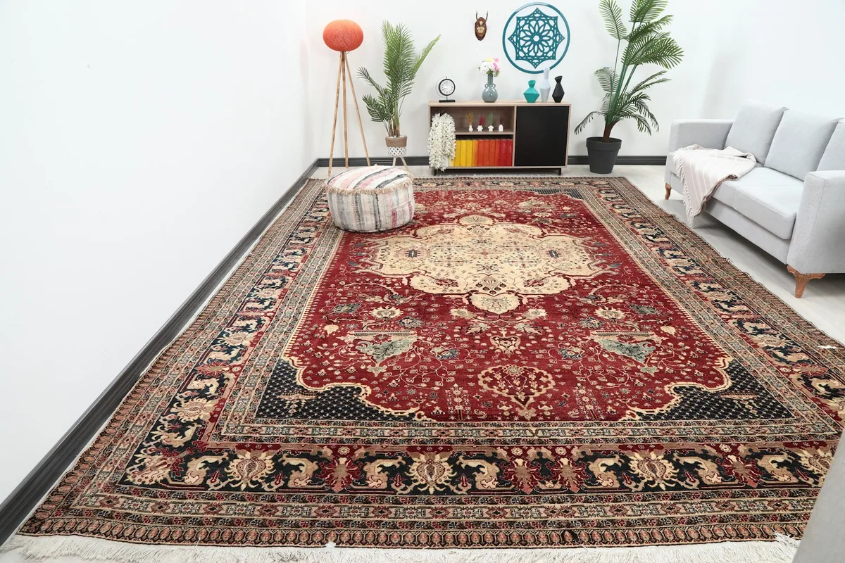 Oversized red and beige medallion rug displayed in a modern living room setting