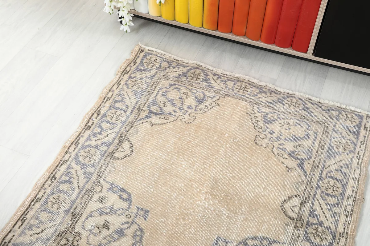 Angled view focusing on one end of the runner rug, showing the arch-like motif and border.