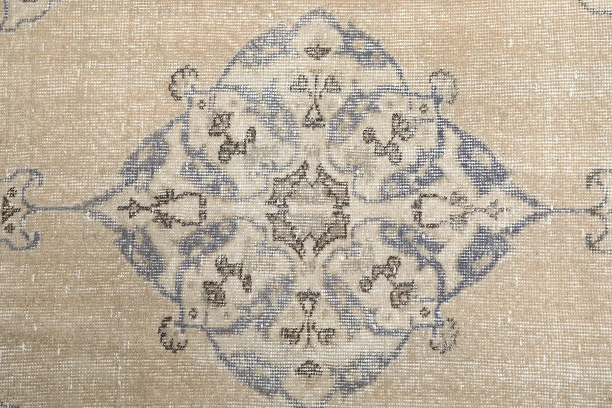 Detailed shot of the central medallion motif, showcasing its intricate patterns and color variations.