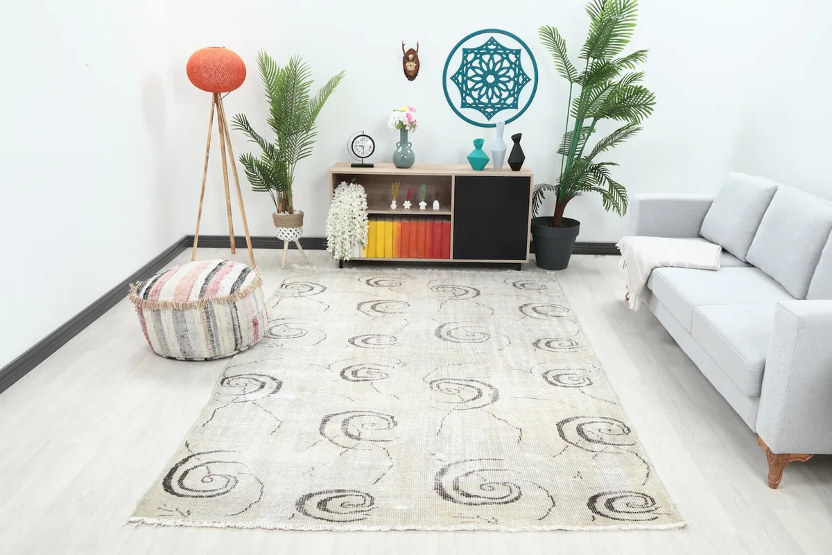 Ivory and charcoal vintage rug displayed in a modern living room setting
