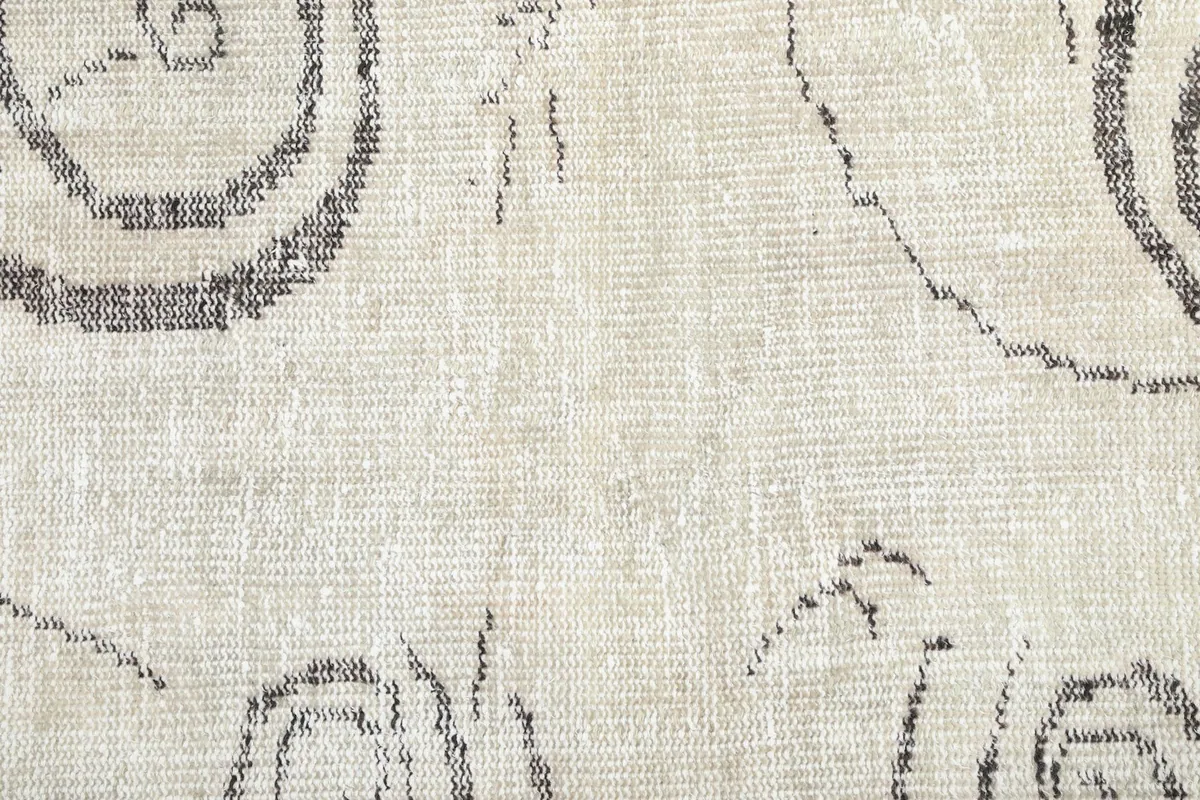 Close-up of the low wool pile and hand-knotted texture of the vintage rug
