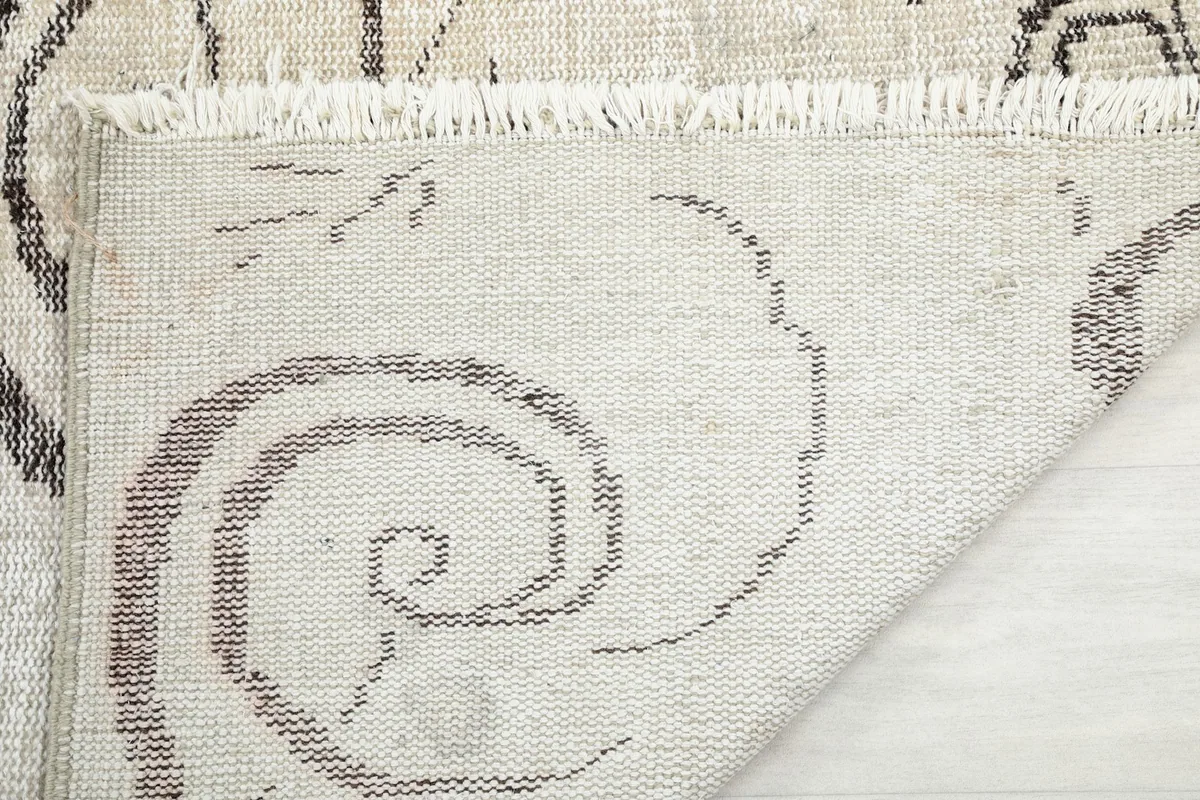 Close-up of the rug's reverse side, showing the cotton foundation