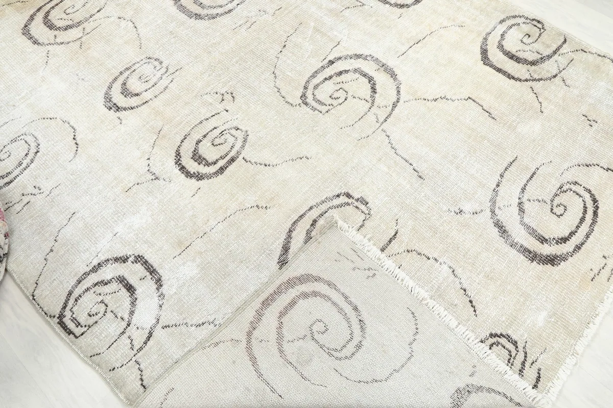 Folded corner of the rug, revealing the backing and pile