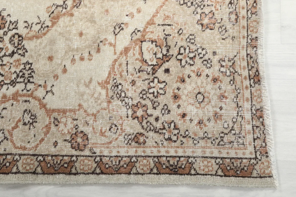 Detail of the Cream Rust Medallion Anatolian Rug's border design with rust and brown tones.