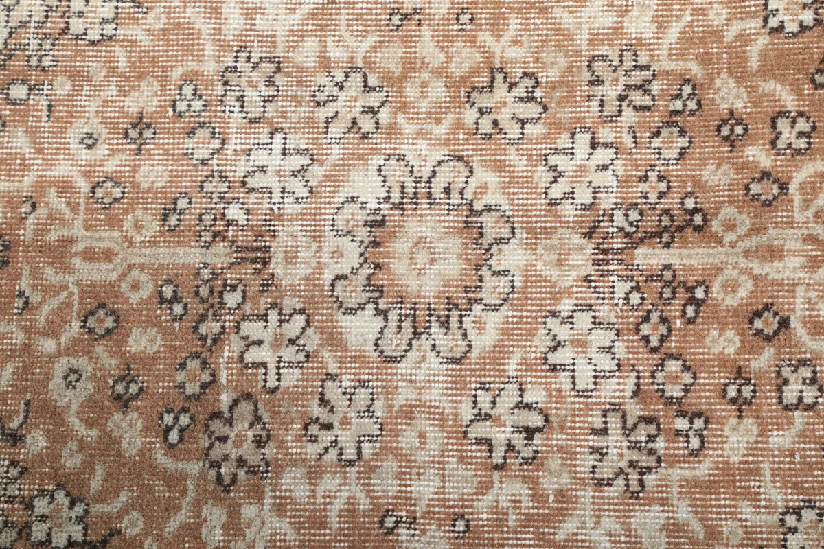 Close-up of the Cream Rust Medallion Anatolian Rug's low pile and intricate floral patterns in the medallion.