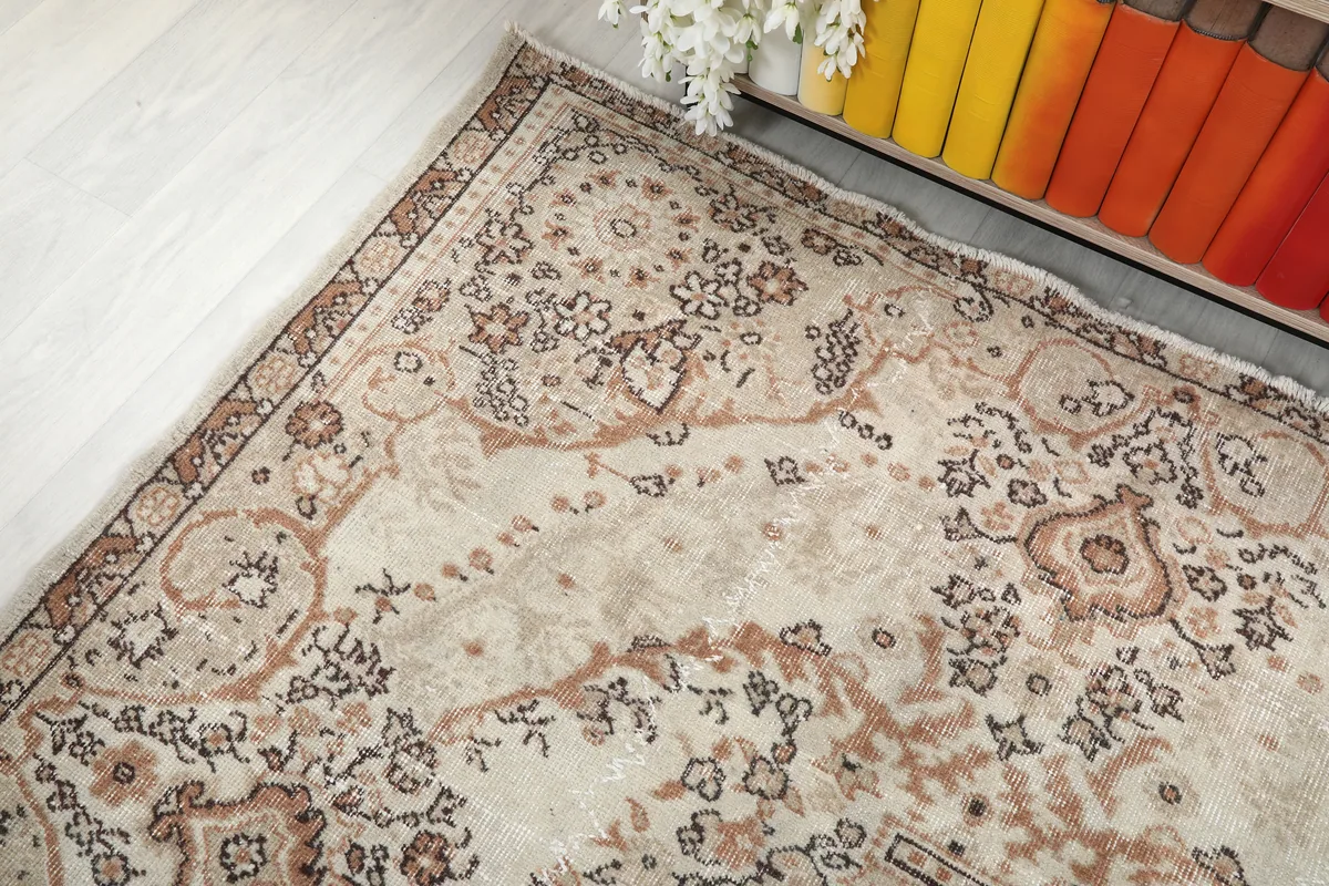 Corner detail of the Cream Rust Medallion Anatolian Rug, highlighting the faded cream and rust colors.