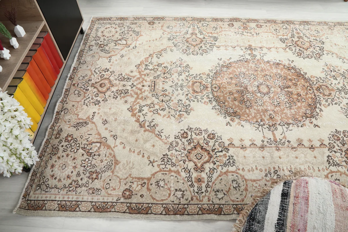 Cream Rust Medallion Anatolian Rug filling a living area, showing its scale next to furniture.