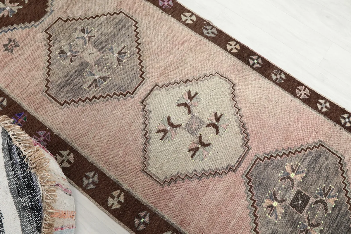 Overhead angled shot of the runner, focusing on the rose field and tribal motifs