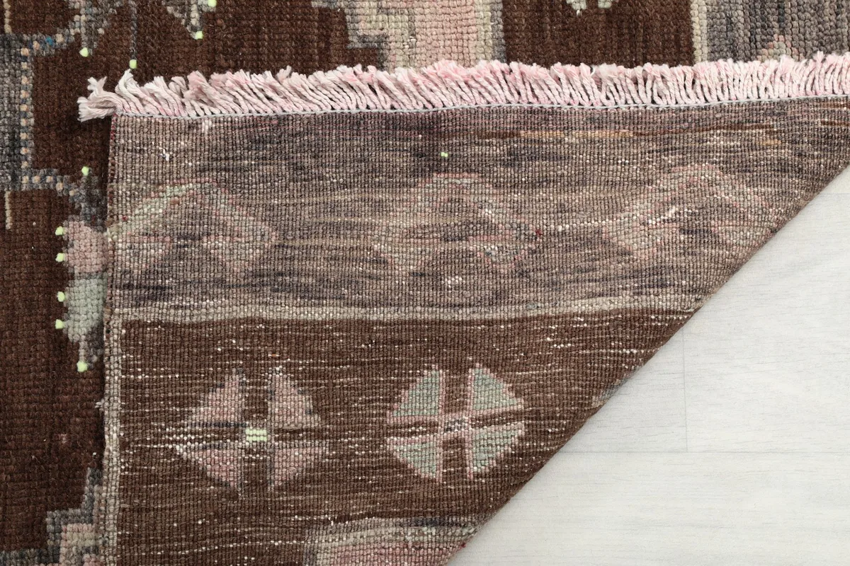 Close-up of the rug's back and fringe, demonstrating the wool pile on cotton foundation