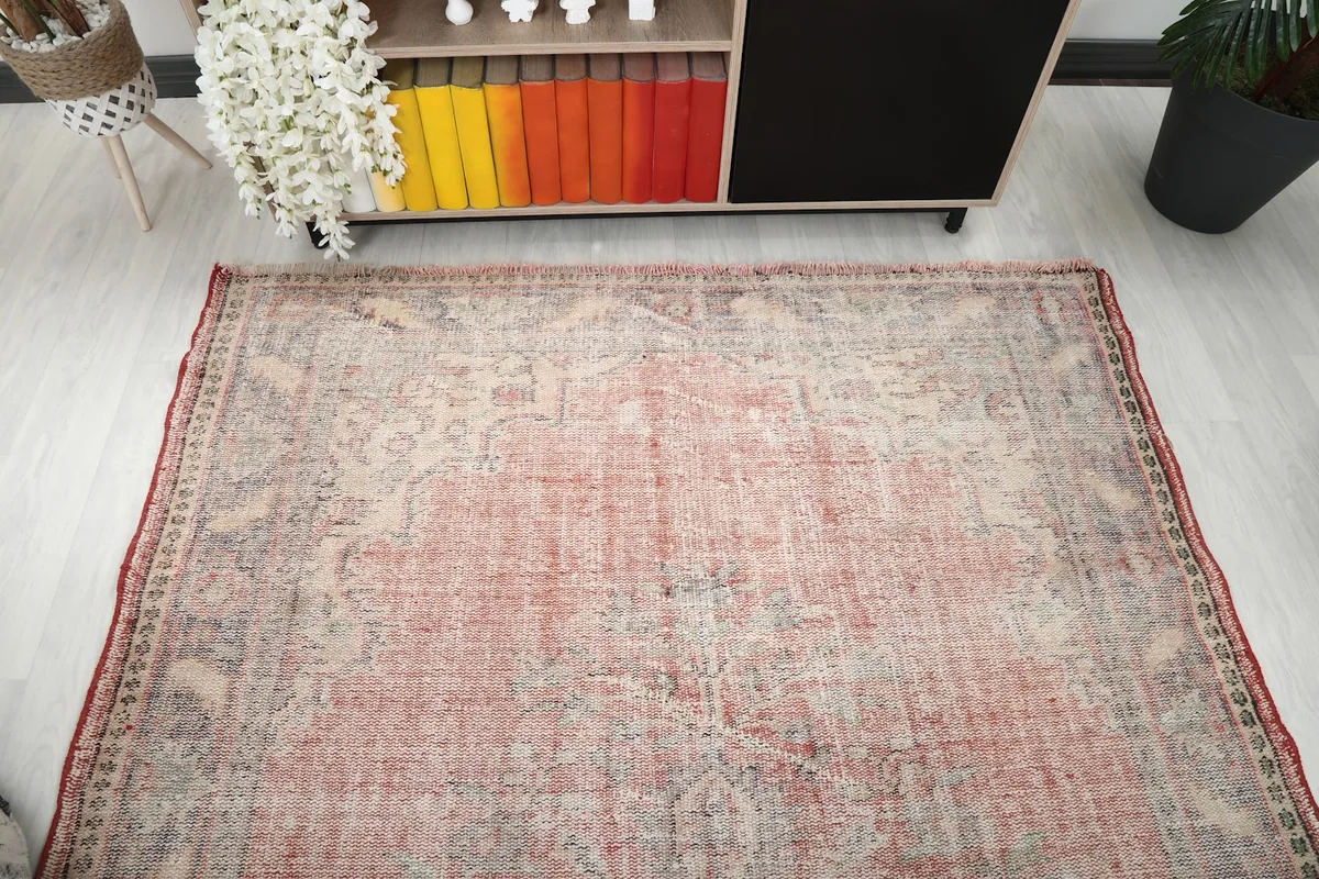 Overhead view of the vintage rose rug in a room, showcasing its overall size and color distribution