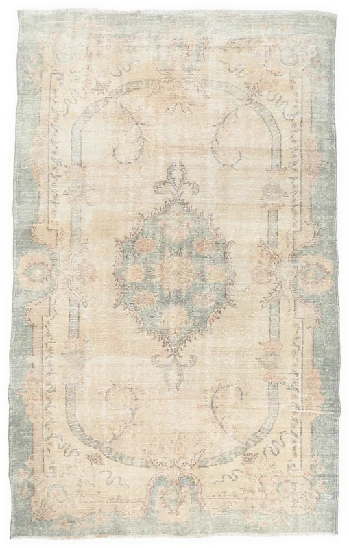 Full overhead view of the vintage ivory and green medallion Anatolian rug