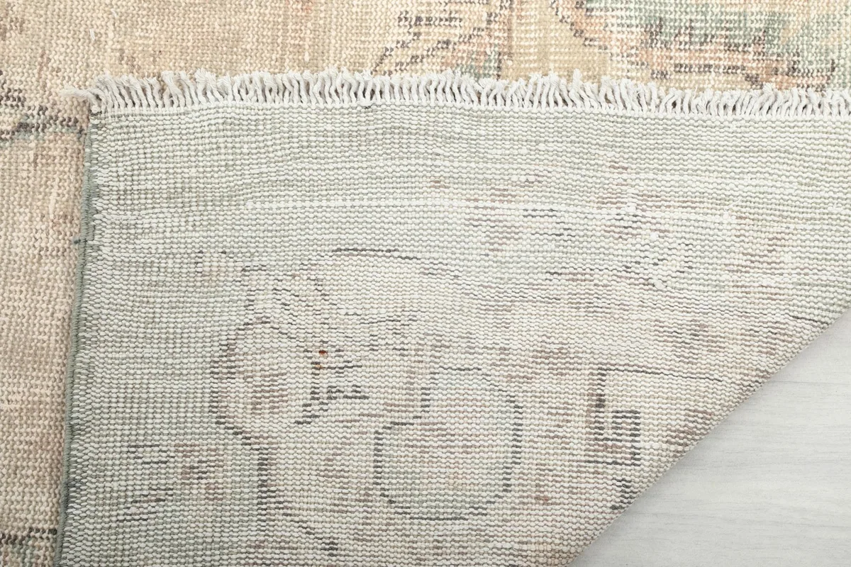 Underside of the hand-knotted rug, revealing the cotton foundation