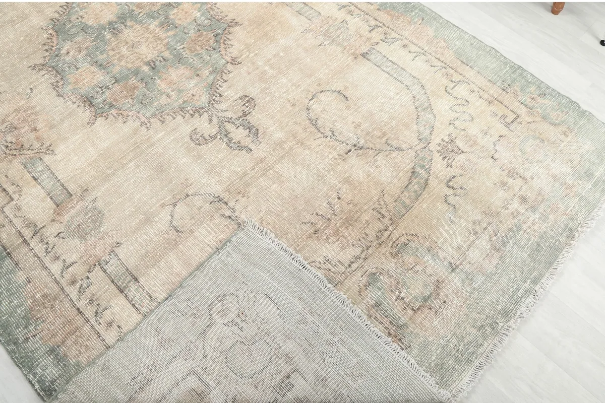 Folded corner of the rug showing the wool pile and cotton foundation